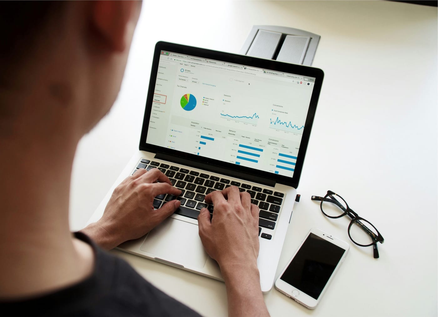 Small business owner comparing RFP databases and bid opportunities on a laptop